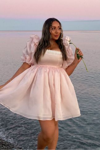 a photo of a woman wearing a pink dress
